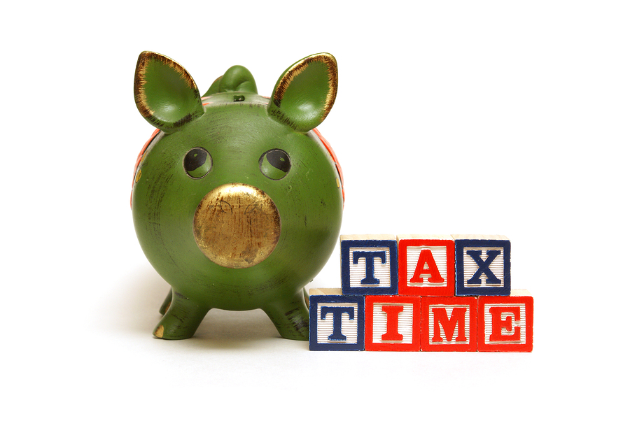 A pig bank and blocks remind people of the tax season.